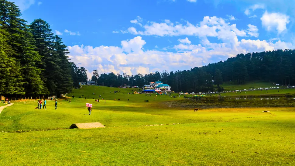 Lush green meadows and serene lake in picturesque Khajjiar