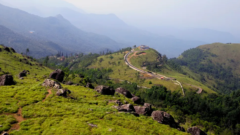 Mist-covered hills and valley view at Ponmudi during monsoon