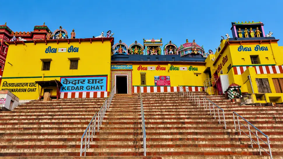 Colourful red and white steps of Kedar Ghat near Kedareshwar Temple