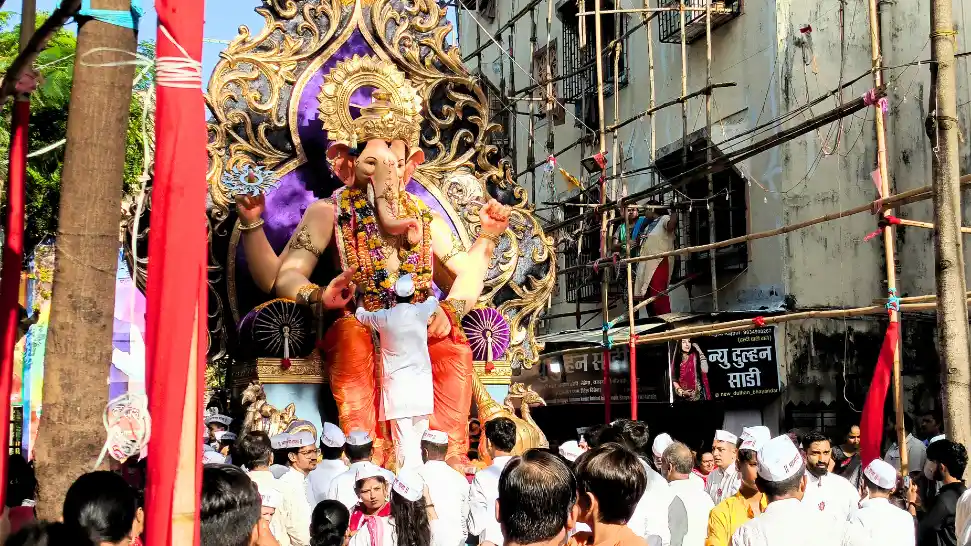 Ganesh Chaturthi celebration in Mumbai featuring a decorated Lord Ganesha idol and festive procession