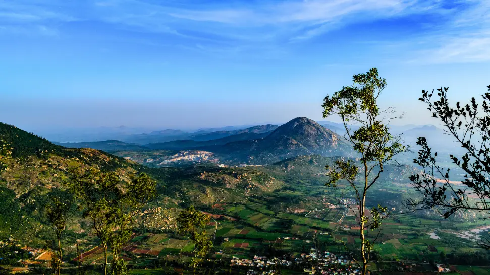 Sunrise view from Nandi Hills near Bangalore with clouds and green valleys