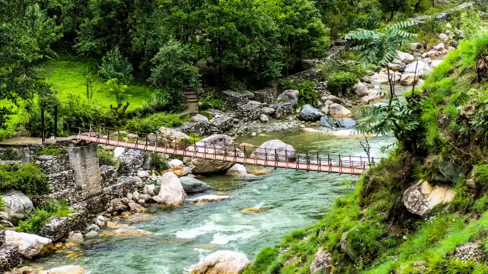 Crystal-clear river flowing through the scenic Tirthan Valley