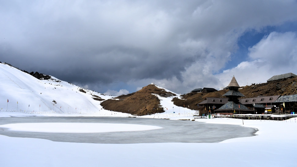 Prashar Lake frozen in snow with temple view